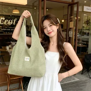 Green gingham canvas tote bag detail view showing casual style and spacious daily use.