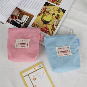 Close-up detail of mini nylon plaid zipper coin purse, portable cute pouch for daily essentials.
