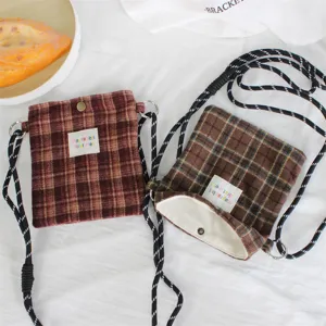 Retro woolen plaid mini crossbody bag with drawstring strap and woven label detail for daily use.