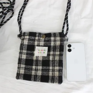 Retro black and white plaid mini shoulder bag detail, wool cross-body phone bag close up.