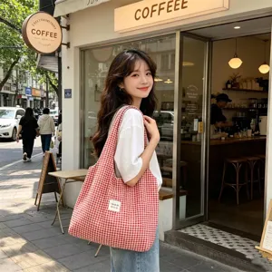 Red and white plaid canvas tote bag lifestyle detail shot, casual daily commute shoulder bag style.