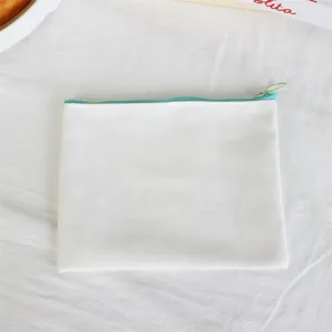 Minimalist white canvas pencil case with bright blue zipper, clean flat lay detail view.