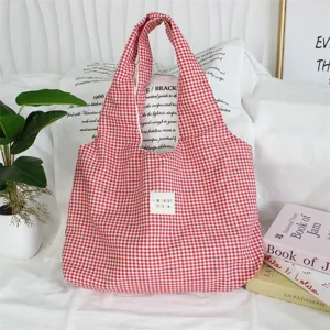 Red and white gingham tote bag detail view showing soft fabric texture and cute woven label.