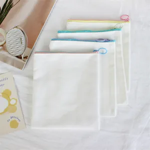 White canvas pencil case detail showing colorful zippers and clean texture for DIY storage bag.