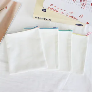 Detail shot of blank canvas pencil pouches with colorful zippers, perfect for DIY and custom logo.