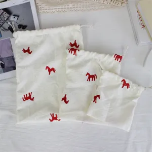 Korean minimalist embroidered pony drawstring bag, white fabric storage pouch for travel.