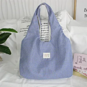 Blue and white gingham tote bag close up, casual canvas shoulder bag detail view.