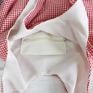 Detailed view of red white gingham canvas shoulder tote bag inner zipper pocket lining.