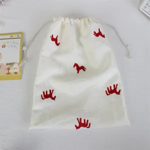 Korean minimalist embroidered pony drawstring bag, white fabric storage pouch for travel cosmetics.