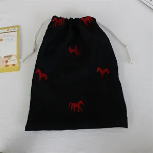 Black minimalist embroidered pony drawstring bag for travel cosmetics and portable storage.
