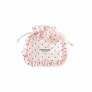 INS style pink satin polka dot drawstring bag for jewelry and cosmetic storage with ruffles.