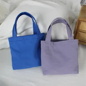 Solid color nylon mini tote bag casual lightweight handbag portable storage pouch daily use.