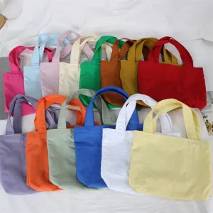 Detail view of colorful nylon mini tote bags, showing various solid colors and compact design.