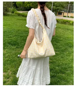 Casual polka dot shoulder bag for women, large capacity hobo bag with ruffled strap.