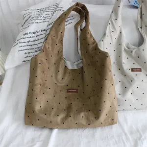 Detailed close-up of retro suede polka dot shoulder hobo bags in cozy bedroom setting.