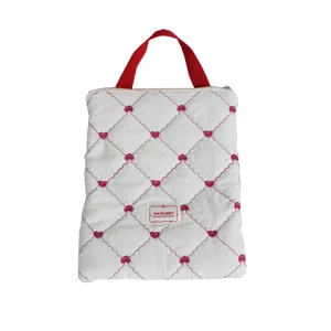 Quilted laptop sleeve bag with cute pink heart embroidery and red handle for daily commuting.