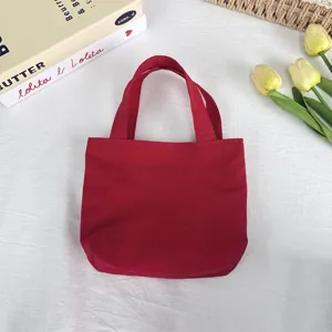 Detailed close-up shot of the red nylon mini tote bag, highlighting smooth fabric and texture.
