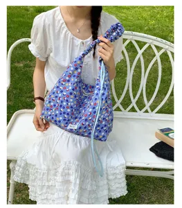 Blue floral shoulder bag for women, casual slouchy hobo bag with adjustable scrunchie strap.