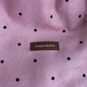 Vintage suede polka dot bag fabric detail, soft texture and stylish pattern showcase.