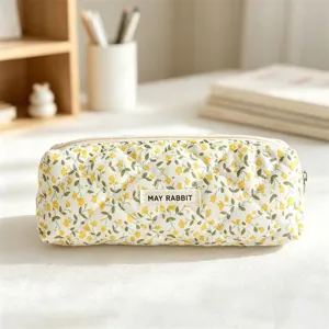 Quilted floral cosmetic bag detail close-up, cute stationery pencil case with smooth zipper.