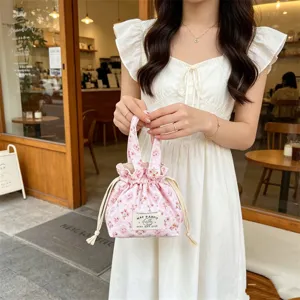 Chic floral corduroy handbag with drawstring closure, cute mini tote bag for daily use.