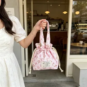 Pink floral corduroy handbag with drawstring closure, cute aesthetic bento pouch for daily use.