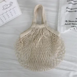 Detailansicht der beigen geflochtenen Netztasche, hohle Einkaufstasche für Strand und Alltag.
