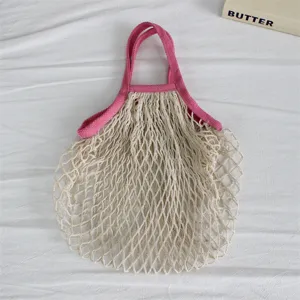 Baumwoll Netz Einkaufstasche mit rosa Griffen, umweltfreundlicher wiederverwendbarer Beutel.