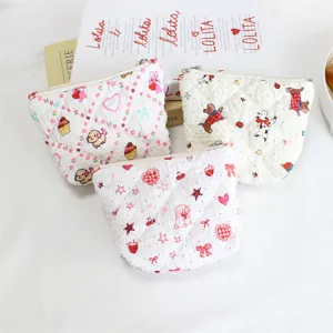 Detailed view of quilted cosmetic bags with cute cartoon prints, soft zippered coin purse.