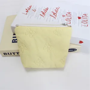 Yellow quilted bow makeup pouch detail, cute cosmetic bag zipper storage zipper pocket.