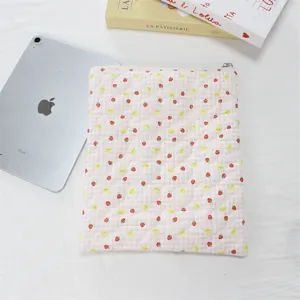 Pink quilted tablet pouch detail featuring cute strawberry and bear pattern, soft aesthetic design.