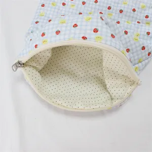 Quilted zipper storage pouch with cute strawberry and bunny print and dotted inner lining detail.