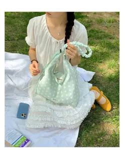 Green polka dot hobo shoulder bag with adjustable shirred strap for women daily use.