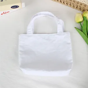 Detailed view of a minimalist white mini handbag, clean fabric texture and simple everyday style.