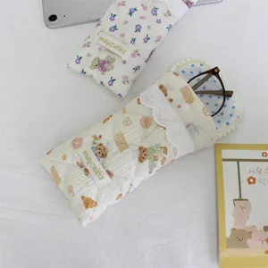 Cute quilted glasses storage pouch with soft padding, lace trim, and portable snap button design.