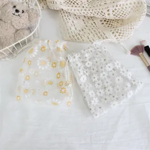 Little daisy embroidered mesh drawstring storage bag for jewelry and cosmetics organization.