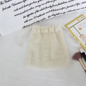 Beige mesh drawstring bag for jewelry and cosmetics storage, portable gift candy packaging.