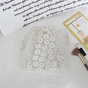 White daisy embroidered mesh drawstring bag for jewelry and cosmetic storage gift packaging.