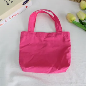 Stylish hot pink nylon mini tote bag, lightweight waterproof handbag for daily use and travel.