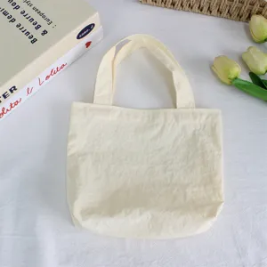 Solid color nylon small handbag minimalist lightweight waterproof mini tote bag for daily casual use.