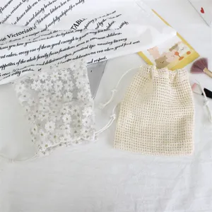 Daisy embroidered mesh and cotton net drawstring storage bags for cosmetics and jewelry.