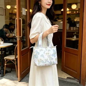 Ins style vintage butterfly embossed jacquard bento lunch handbag detailed view in cafe.