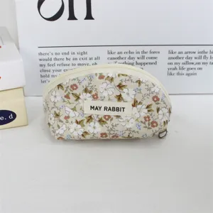 Cute floral half-round coin purse canvas makeup bag with zipper and aesthetic label design.