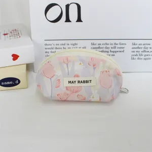 Detail view of cute pink tulip print shell cosmetic pouch with metal zipper and fabric label.