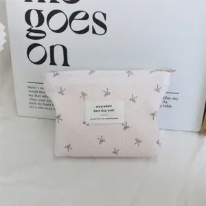 Pink corduroy makeup pouch with cute bow pattern, portable zipper storage bag for daily use.