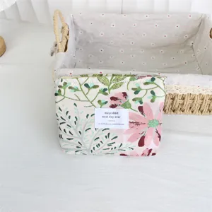 Detailed view of retro floral jacquard cosmetic pouch, portable canvas makeup bag texture.