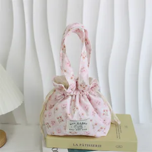 Pink floral corduroy handbag detail, cute drawstring pouch design, casual daily storage bag.