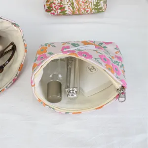 Retro floral jacquard cosmetic bag detail view, showing spacious interior and smooth zipper.