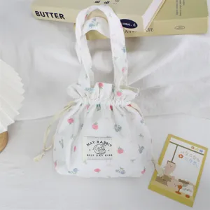 Close-up detail of the floral corduroy drawstring handbag showing soft texture and cute print.