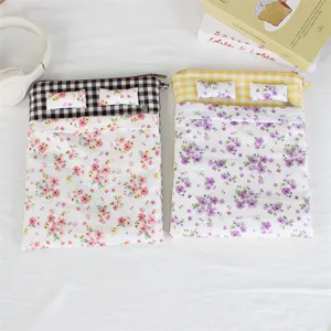 Detailed close-up view of the cute bed-shaped quilted laptop sleeve featuring cozy floral quilt.